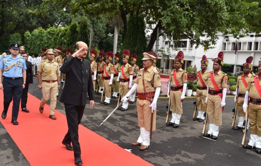 Governor Ramen Deka hoisted the flag at Raj Bhavan and took  salutes