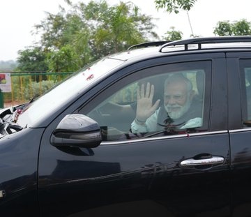 Prime Minister Modi greets the public by waving his hand symbolically expressing his best wishes at Nava Raipur ….